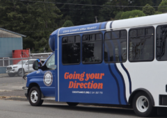 Coos County Area Transit blue and white bus, "Going Your Direction."